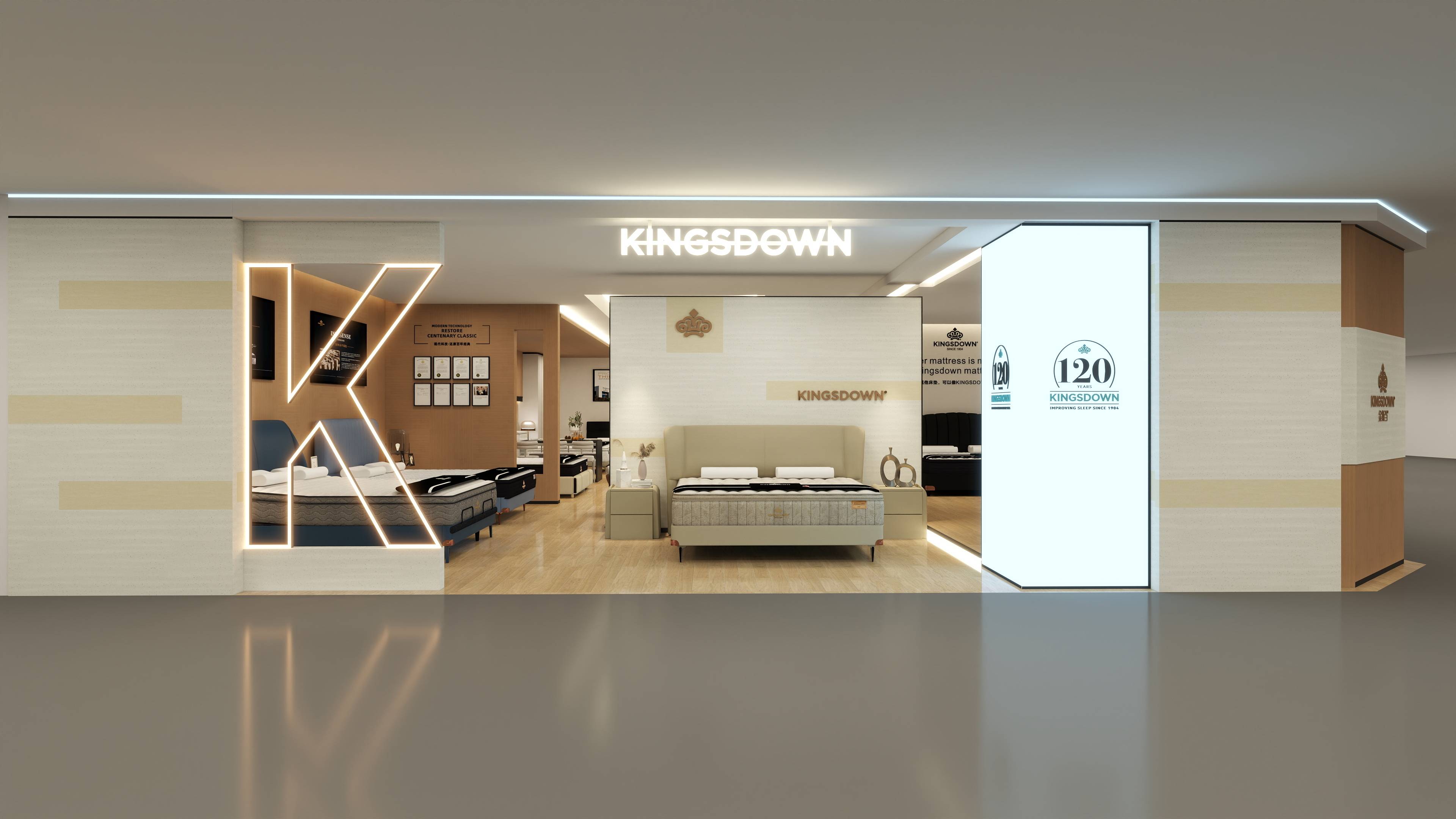 KINGSDOWN品牌床垫专卖店入口设计，现代简约轻奢风格。顶部悬挂醒目白色发光品牌招牌，左侧设巨型“K”字霓虹灯带造型，右侧立柱展示“120周年”品牌历史标识